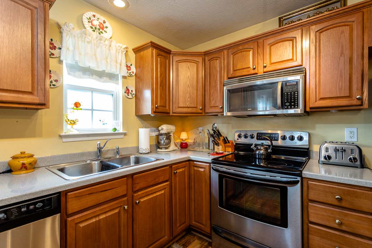128 Gentry Road Weyers Cave, VA 24486 - Photo 13 of 48 a kitchen with stainless steel appliances a stove a sink a oven and a microwave