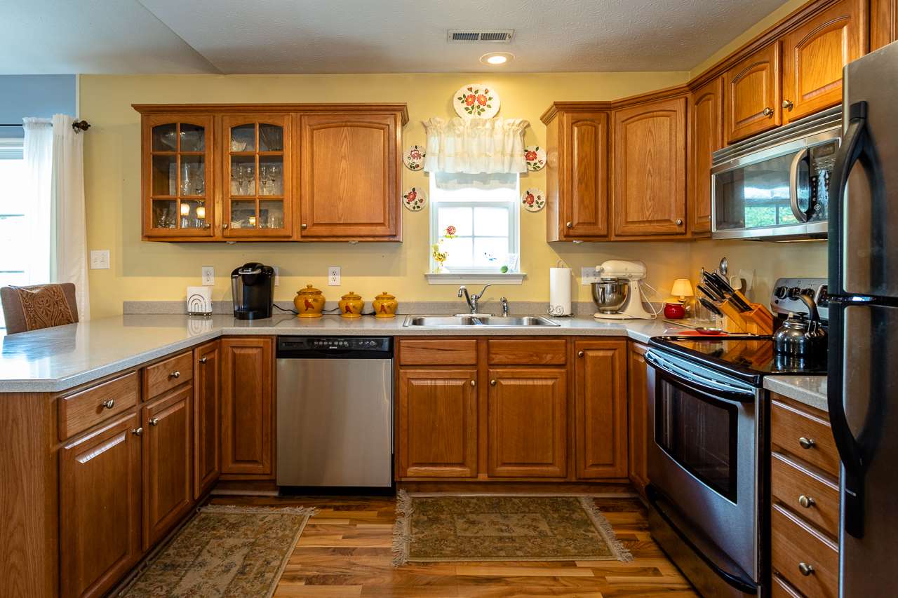 128 Gentry Road Weyers Cave, VA 24486 - Photo 15 of 48 a kitchen with stainless steel appliances granite countertop a stove sink and cabinets