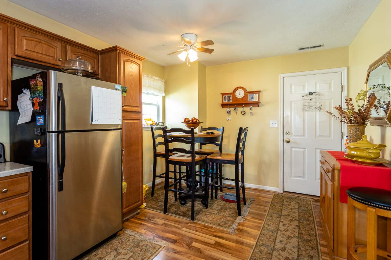 128 Gentry Road Weyers Cave, VA 24486 - Photo 17 of 48 a kitchen with stainless steel appliances granite countertop a refrigerator and a dining table