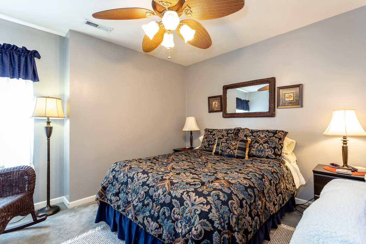 128 Gentry Road Weyers Cave, VA 24486 - Photo 27 of 48 a bedroom with a bed and a chandelier