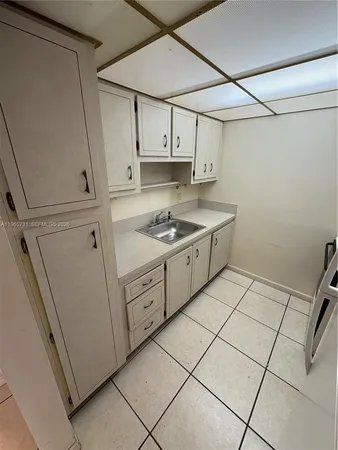 a kitchen with cabinets and appliances