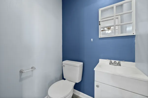 a bathroom with a toilet sink and a window
