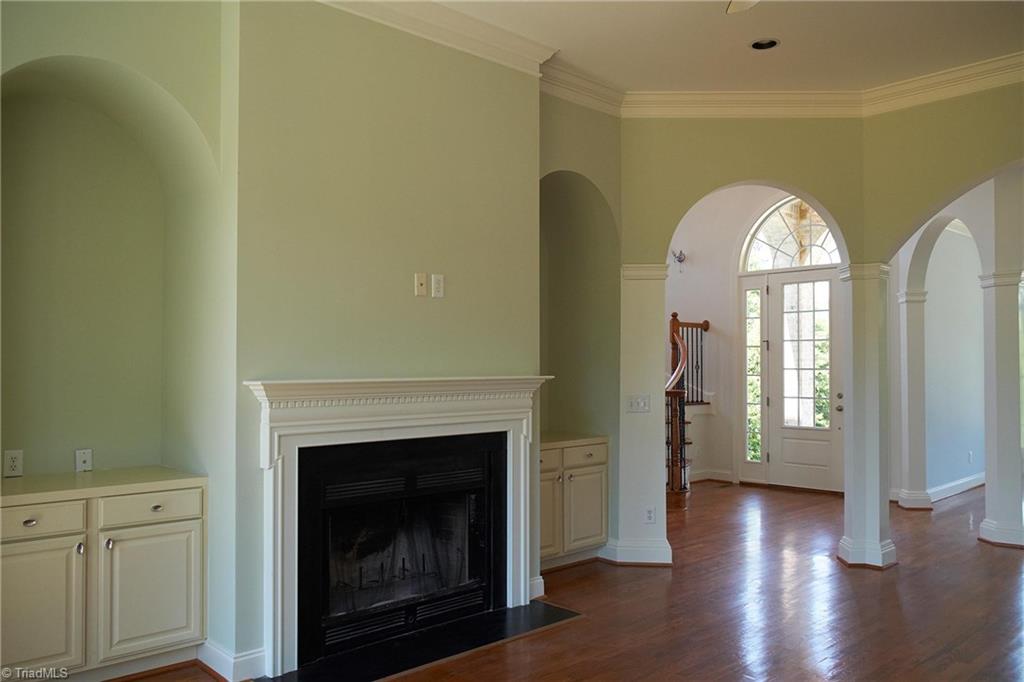 602 Bobcat Road Summerfield, NC 27358 - Photo 13 of 30 Main level living room has a large wood burning fireplace, built in cabinets, and space for a large flat screen TV!