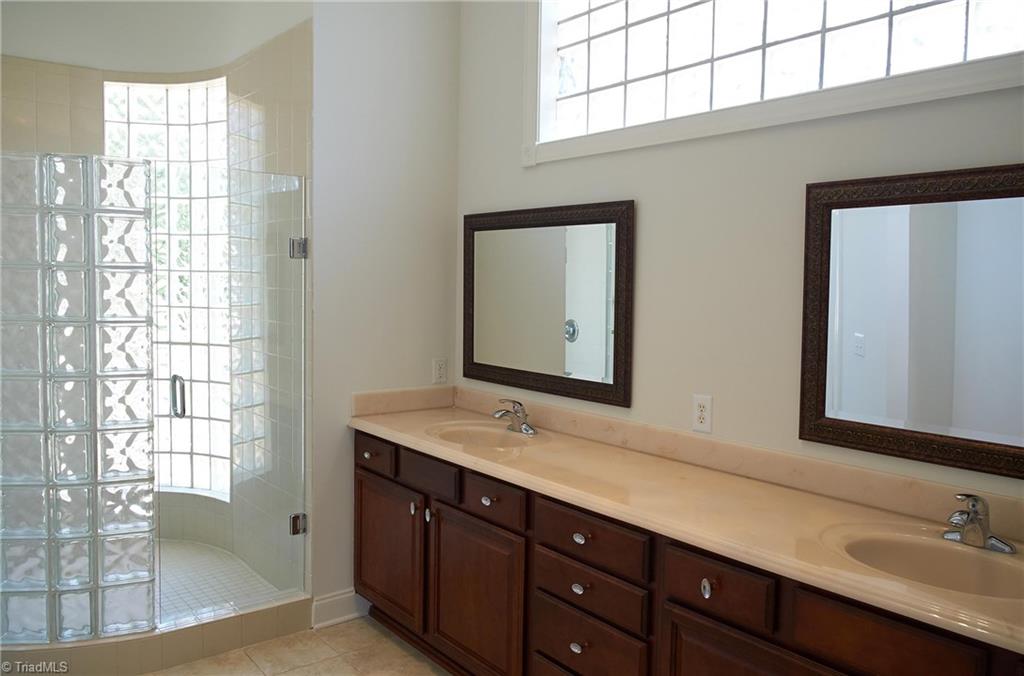 602 Bobcat Road Summerfield, NC 27358 - Photo 16 of 30 Master bathroom has super high ceilings, wall length double vanity, spacious walk-in shower, and separate jetted tub.