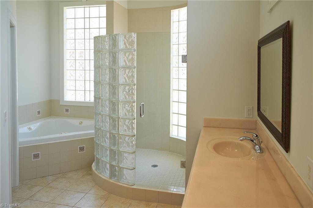 602 Bobcat Road Summerfield, NC 27358 - Photo 17 of 30 Master bathroom has a jetted tub, separate walk-in shower, and a private water closet on the left. Glass blocks allow lots of light while maintaining your privacy!