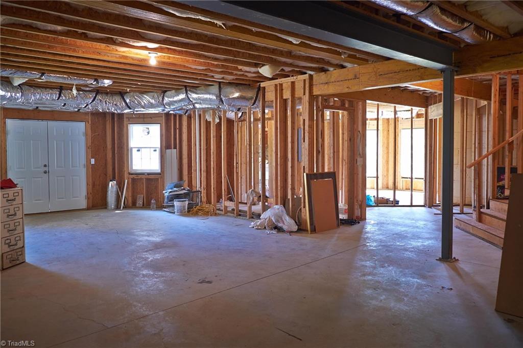602 Bobcat Road Summerfield, NC 27358 - Photo 23 of 30 Full basement with double doors leading to the back yard. Basement has been roughed in with 2 rooms with closet spaces, and a bathroom.
