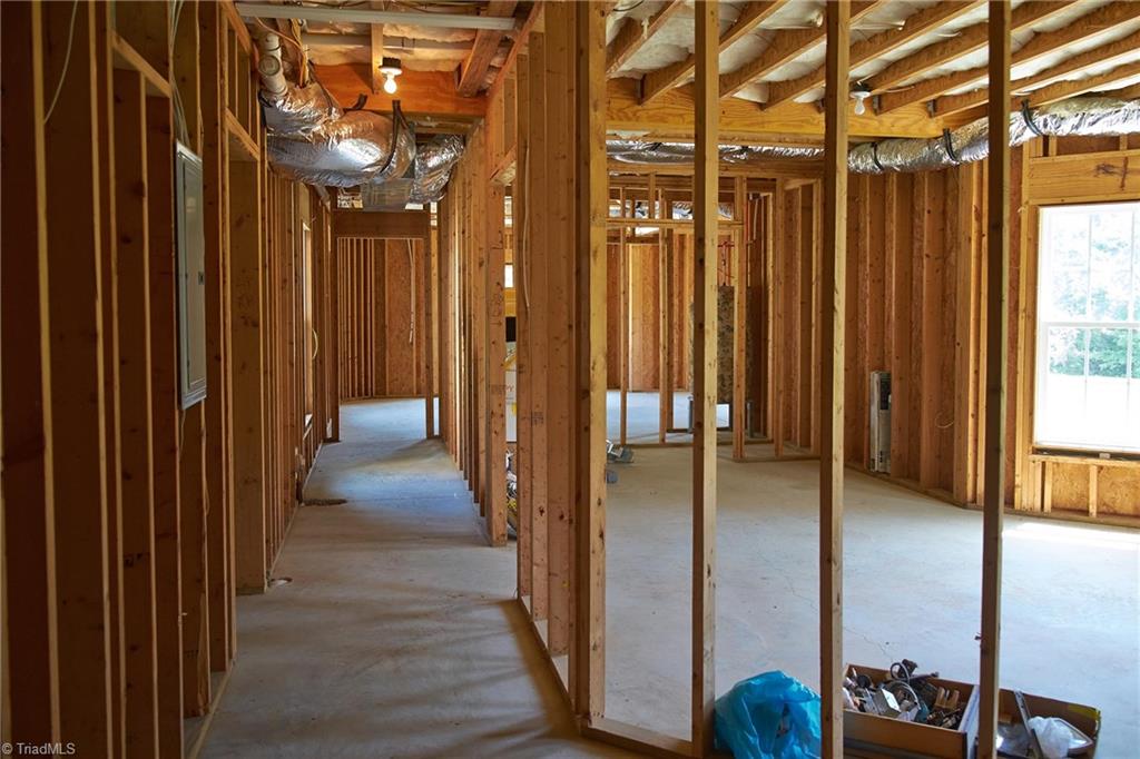 602 Bobcat Road Summerfield, NC 27358 - Photo 24 of 30 Roughed in hallway with plumbing for a bathroom on the left, and 2 rooms with closet space on the right.