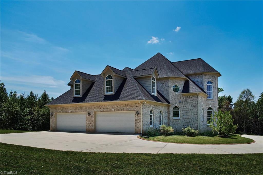 602 Bobcat Road Summerfield, NC 27358 - Photo 25 of 30 There is plenty of parking in the 4 car garage, as well as a paved parking area and circular drive!