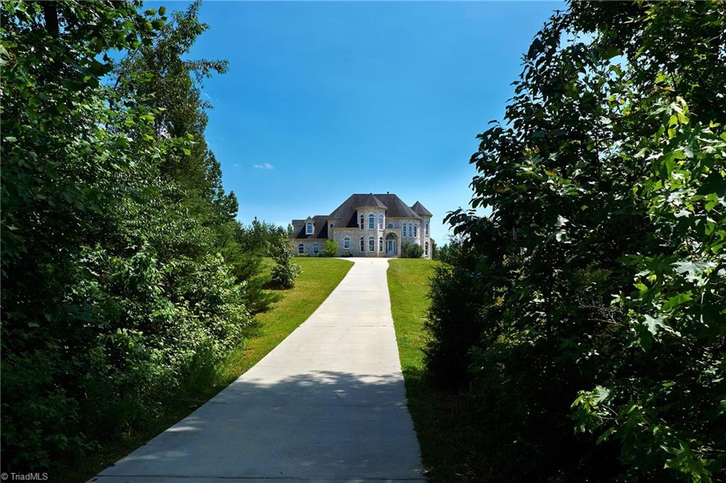 602 Bobcat Road Summerfield, NC 27358 - Photo 29 of 30 This home looks like a castle as you're driving past the trees and down the paved driveway!