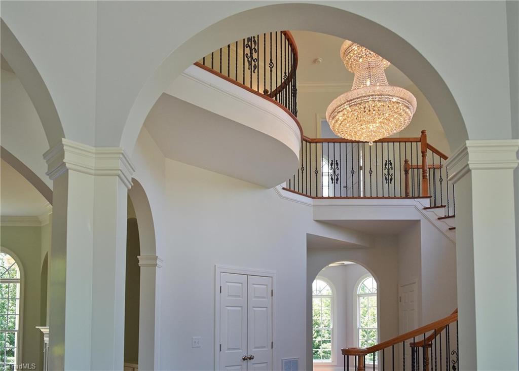 602 Bobcat Road Summerfield, NC 27358 - Photo 4 of 30 Stunning view from the entry! Walk through the arched doorways into Living room on the left, and the office on the right. Guest bedroom with full bath, walk in closet, and walk in attic space is just at the top of the stairs on the right.