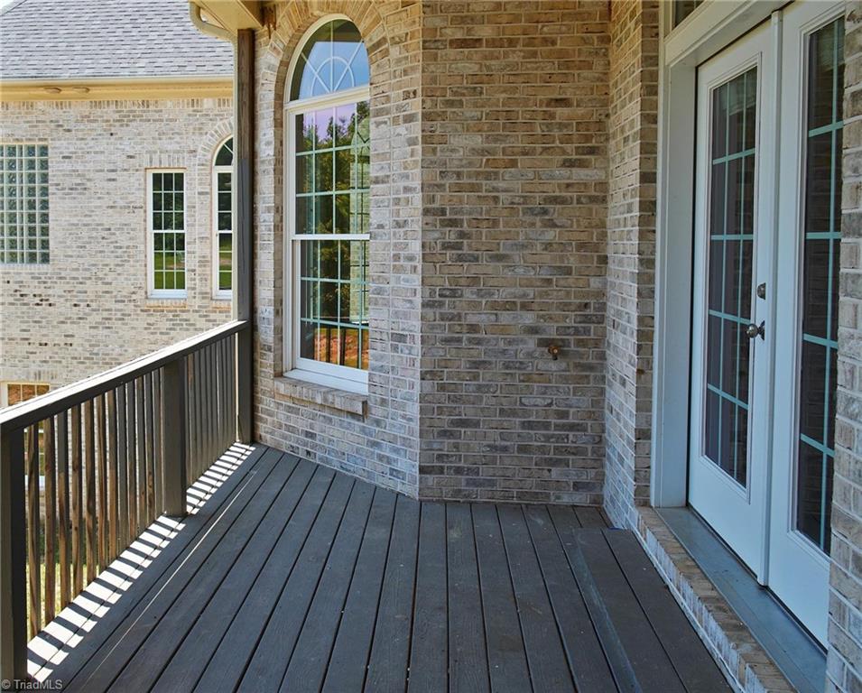 602 Bobcat Road Summerfield, NC 27358 - Photo 10 of 30 Enjoy serenity with your morning coffee on your private deck off the kitchen at the back of the house overlooking 10.2 acres of nature!