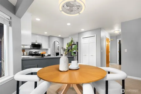 a view of a dining room with furniture a chandelier and wooden floor