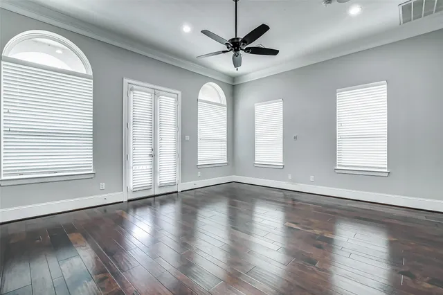 a large kitchen with granite countertop a large window and white cabinets