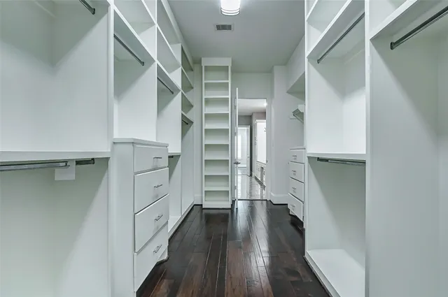 a view of an empty room and wooden floor