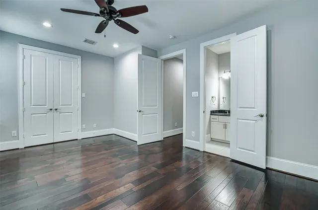 a bathroom with a granite countertop sink a toilet a mirror a bathtub and shower