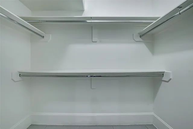 a large kitchen with stainless steel appliances granite countertop a lot of counter space and wooden floor