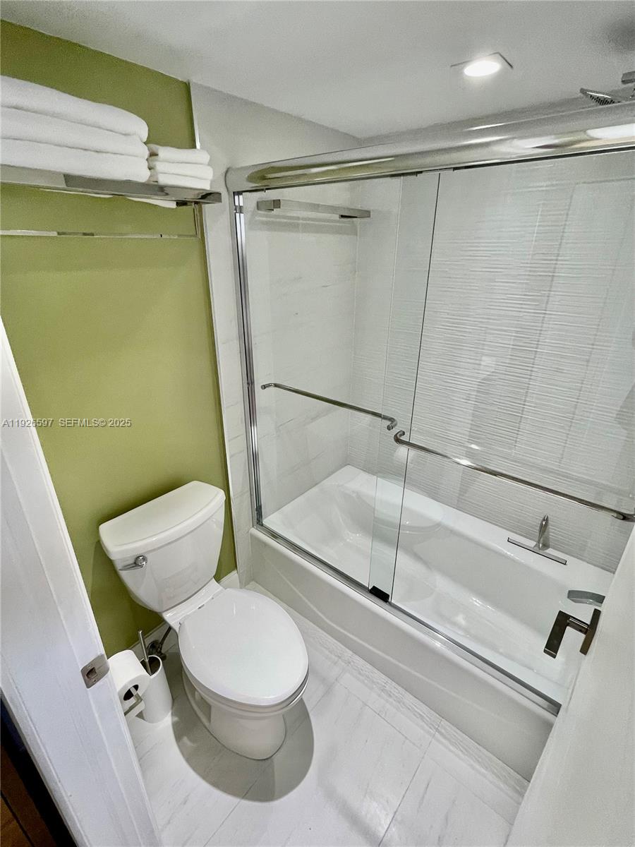 8911 Collins Avenue, Unit 1201 Surfside, FL 33154 - Photo 24 of 27 a bathroom with a toilet and a shower