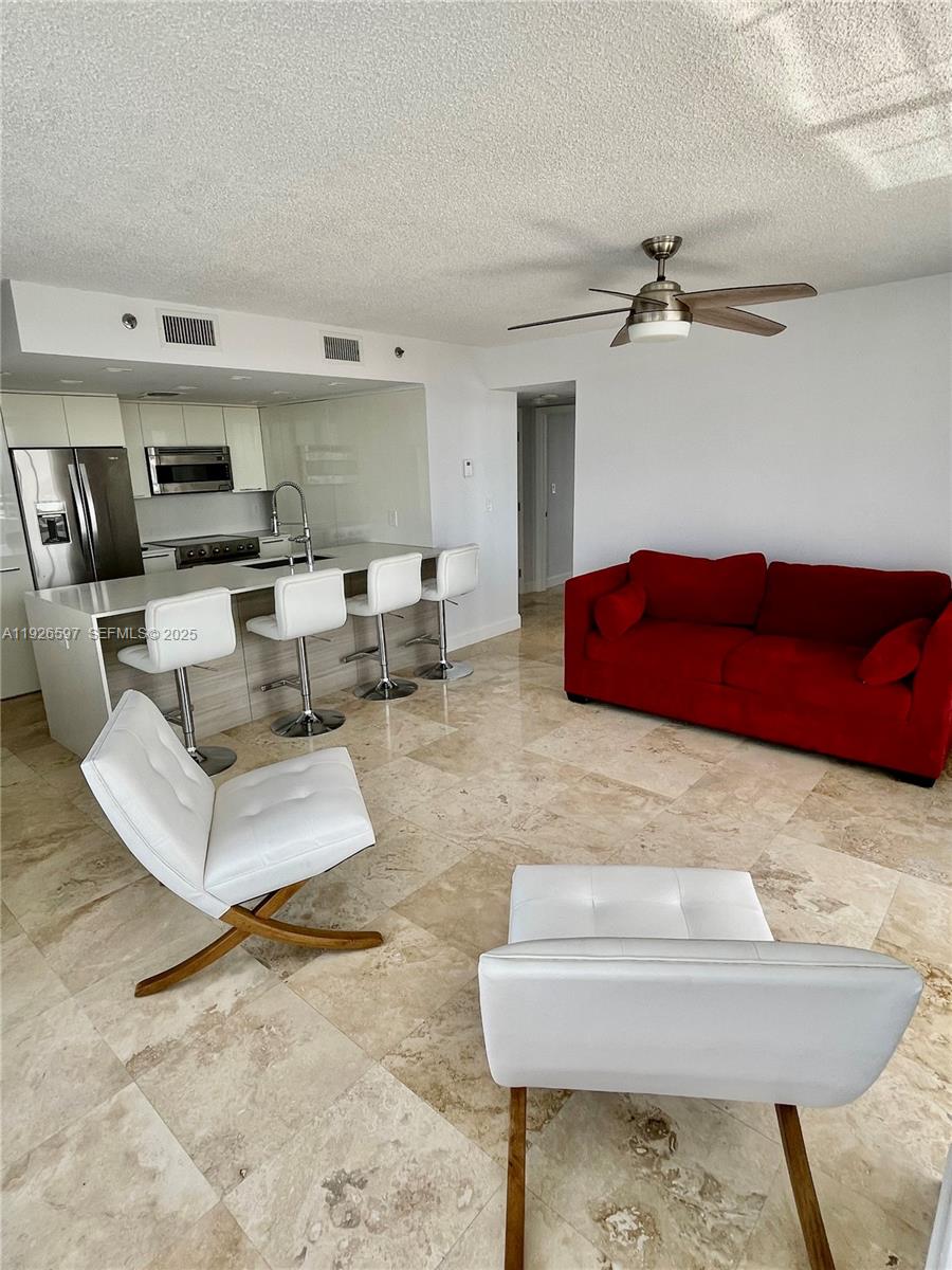 8911 Collins Avenue, Unit 1201 Surfside, FL 33154 - Photo 4 of 27 a living room with furniture