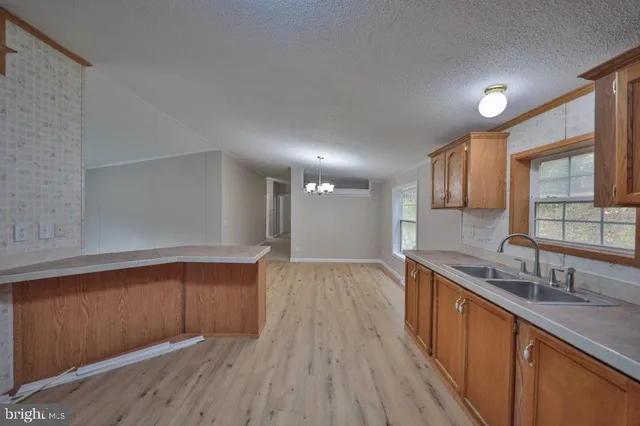 a kitchen with wooden floors and wooden cabinets