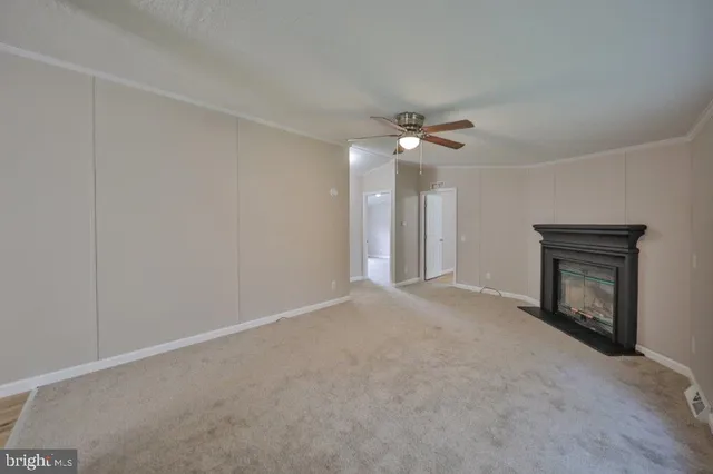 a view of an empty room with a fireplace