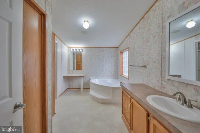 a spacious bathroom with a double vanity sink and a mirror
