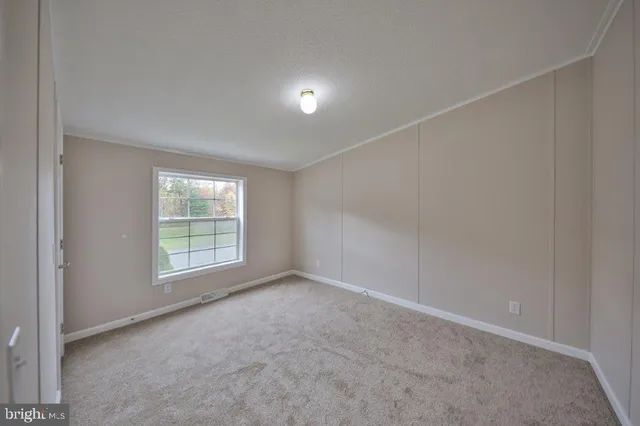 an empty room with a empty space and windows