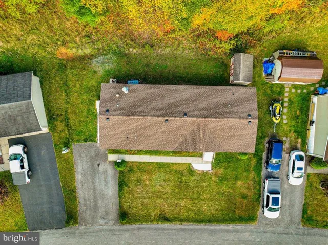 an aerial view of a house with a yard