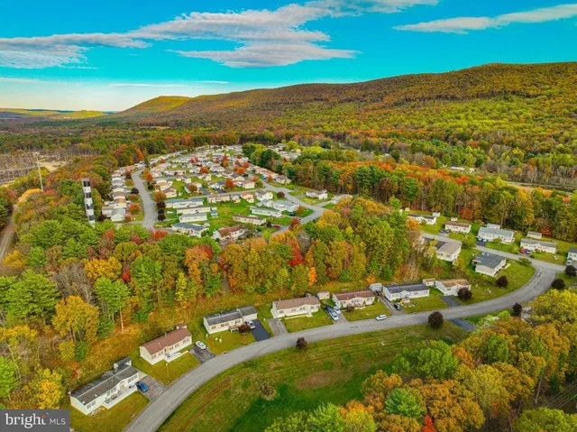 an aerial view of residential houses with outdoor space