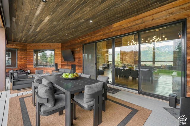 5936 Triple Crown Trail Oakley, UT 84055 - Photo 56 of 57 Covered patio featuring a wood-panel ceiling, wood-paneled walls, and sliding glass doors