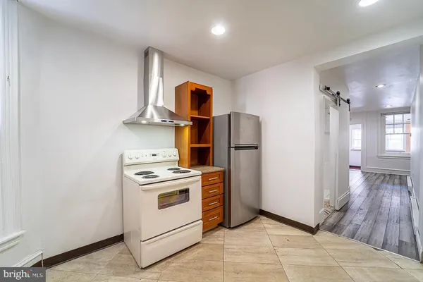 a kitchen with a stove and a refrigerator