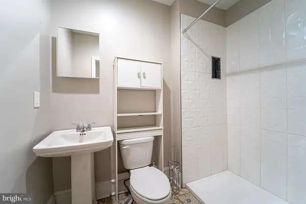 a white toilet sitting next to a bathroom sink