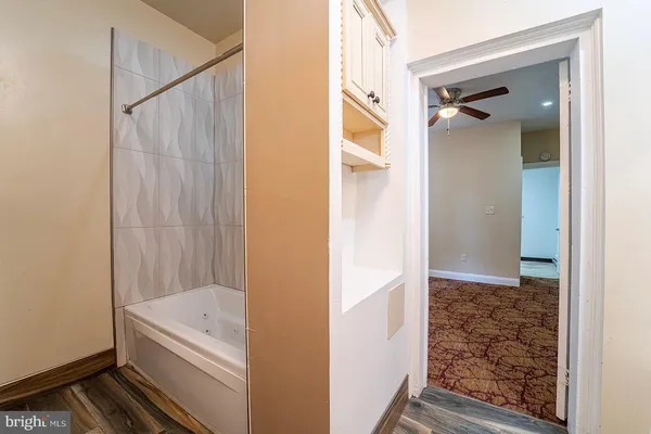 a view of a bathroom with a tub and shower