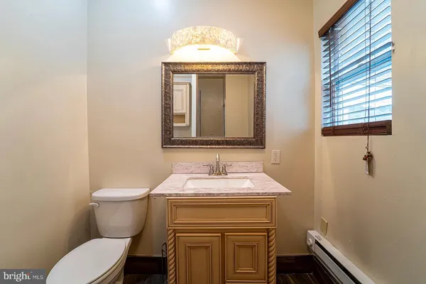 a bathroom with a toilet sink and mirror
