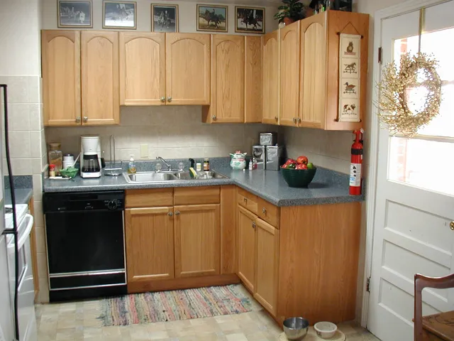 a kitchen with stainless steel appliances granite countertop a refrigerator sink and cabinets