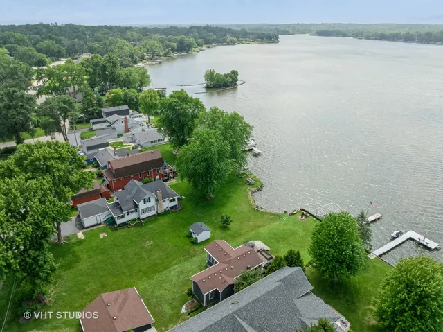 an aerial view of a house with outdoor space and lake view