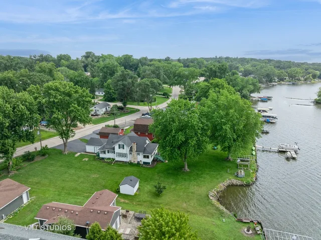 an aerial view of a house with yard