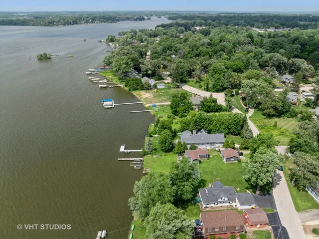 an aerial view of a house with outdoor space and lake view