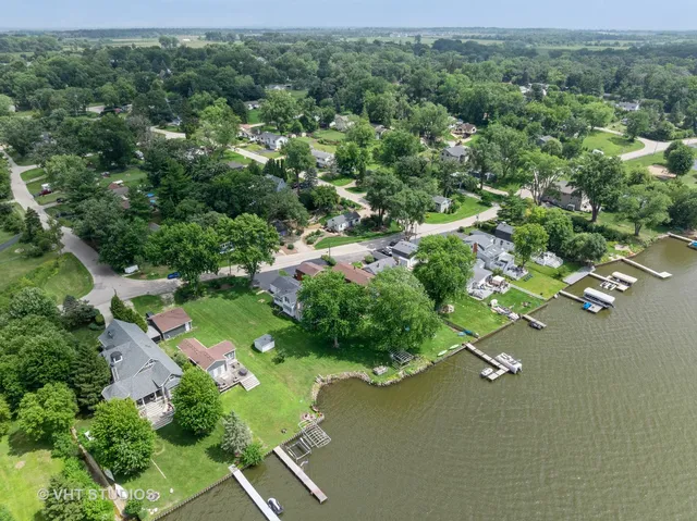 an aerial view of a house with a yard