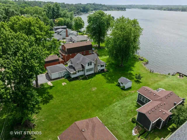 an aerial view of a house with a garden and trees