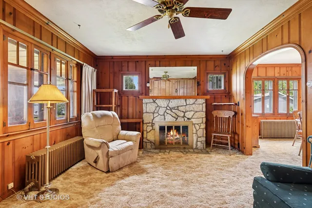 a living room with furniture a flat screen tv and a large window