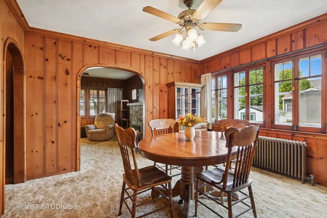 a dining room with furniture window and wooden floor