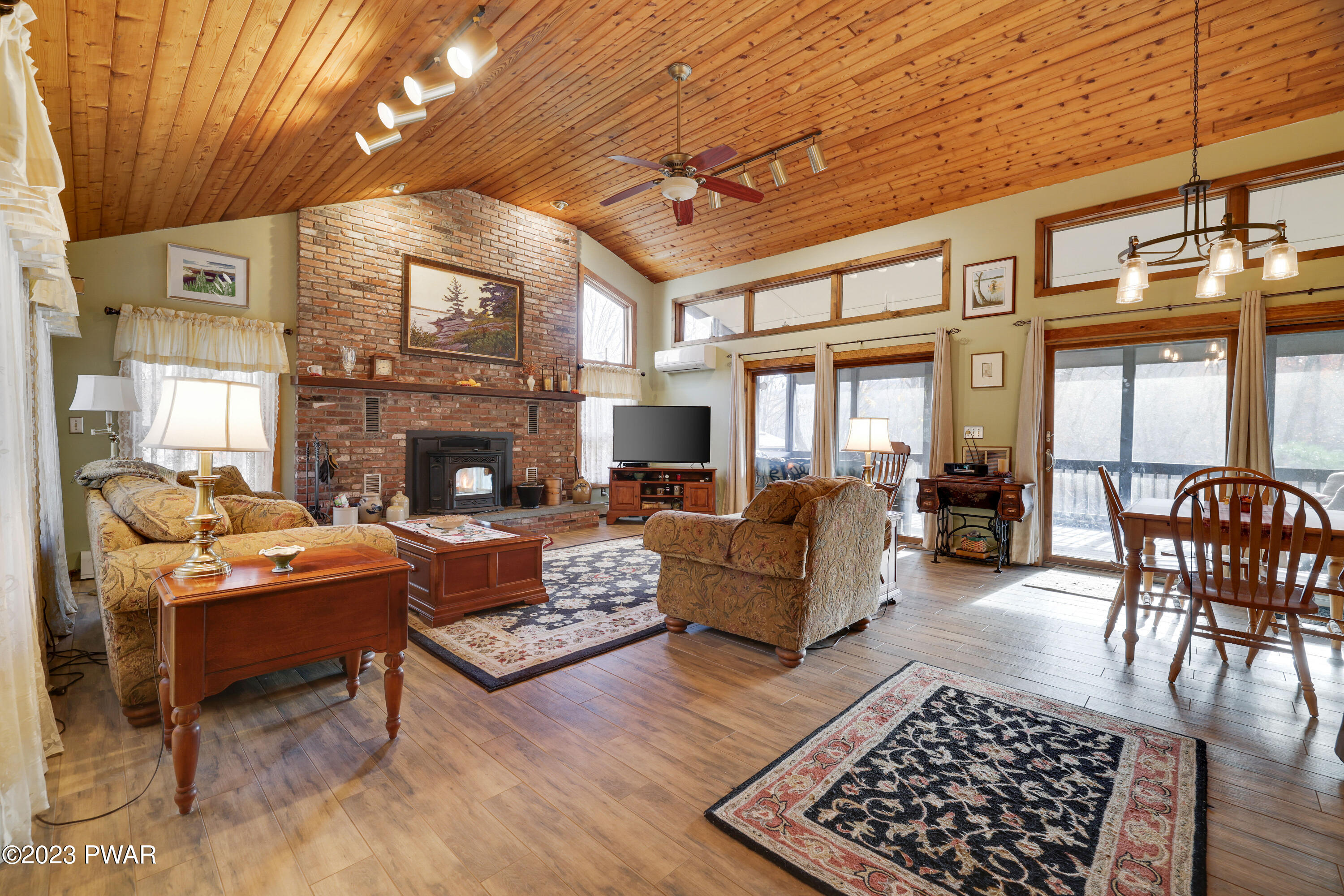 6348 Decker Road Bushkill, PA 18324 - Photo 2 of 36 a living room with furniture a fireplace and a flat screen tv
