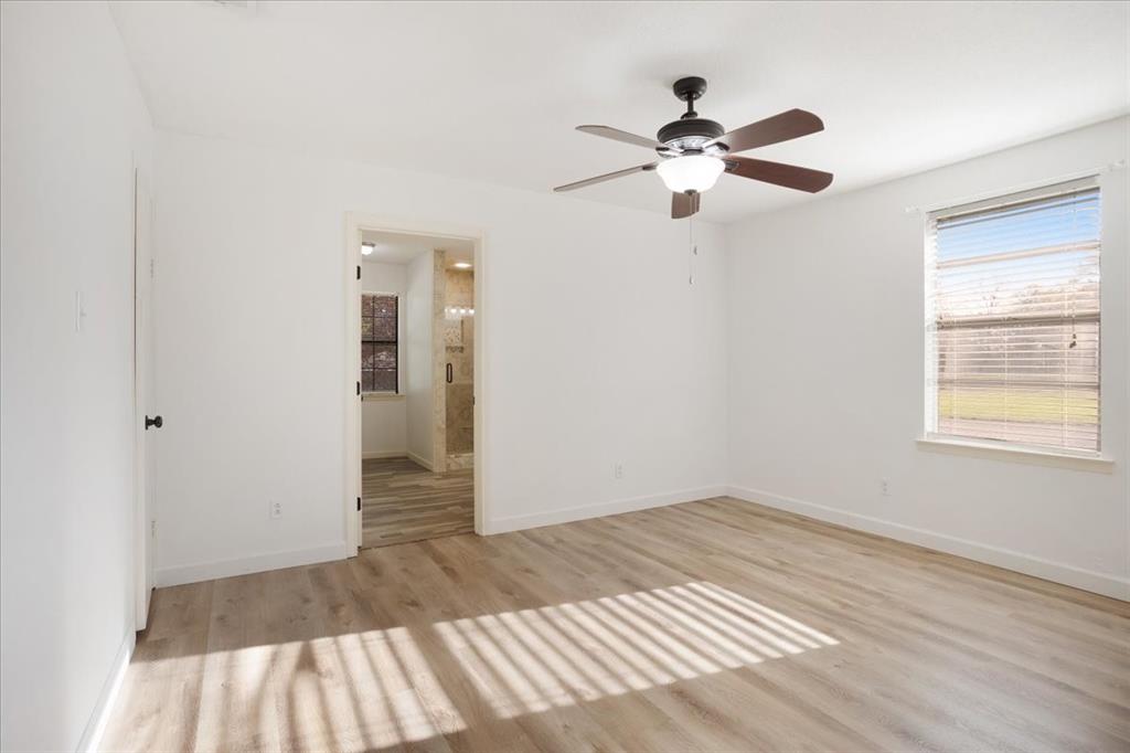 186 Mill Creek Resort Road Pottsboro, TX 75076 - Photo 18 of 40 a view of empty room with wooden floor and fan