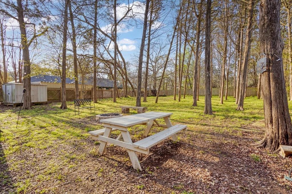 186 Mill Creek Resort Road Pottsboro, TX 75076 - Photo 29 of 40 a view of swimming pool with large trees and wooden fence