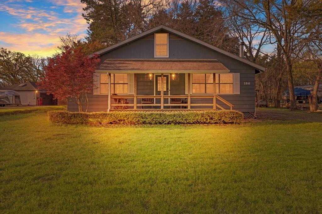 186 Mill Creek Resort Road Pottsboro, TX 75076 - Photo 33 of 40 a front view of a house with a yard
