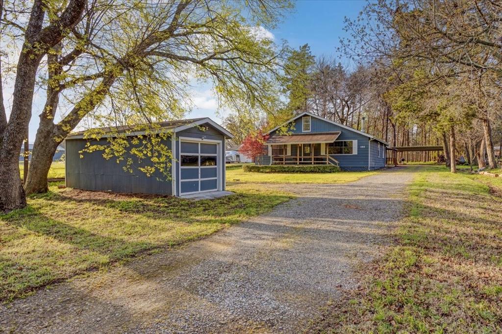 186 Mill Creek Resort Road Pottsboro, TX 75076 - Photo 34 of 40 a front view of a house with a yard and garage