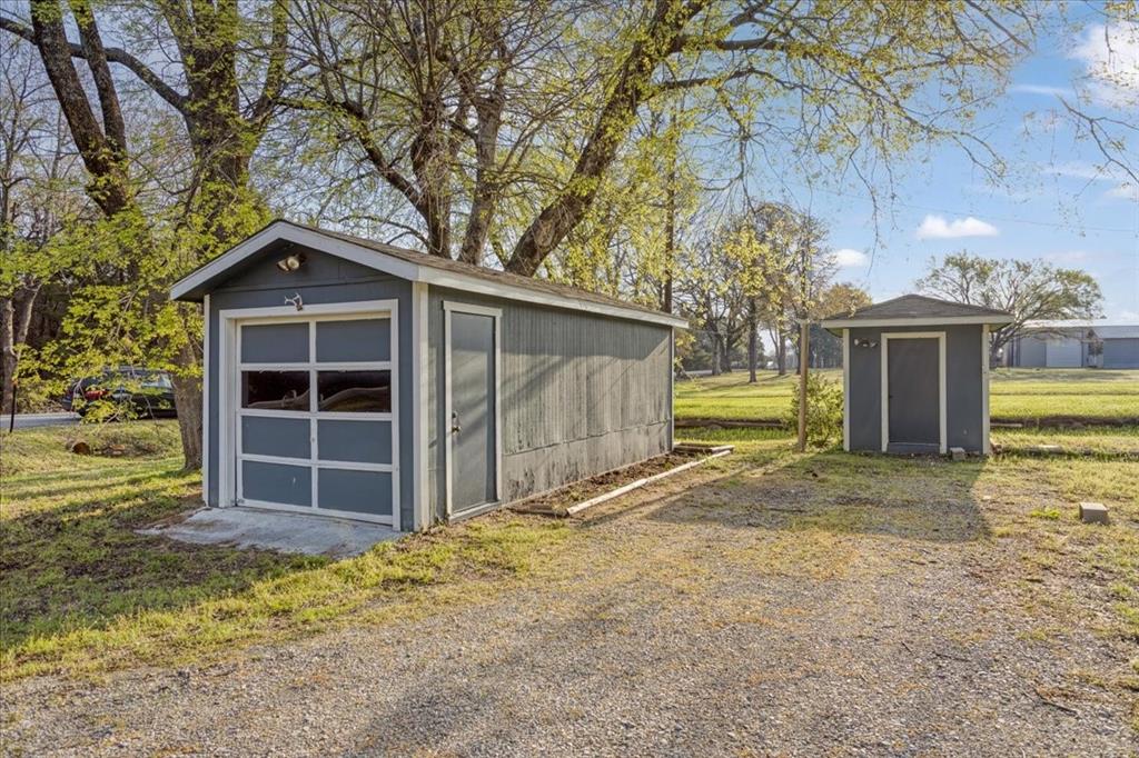 186 Mill Creek Resort Road Pottsboro, TX 75076 - Photo 35 of 40 a front view of a house with a yard and garage