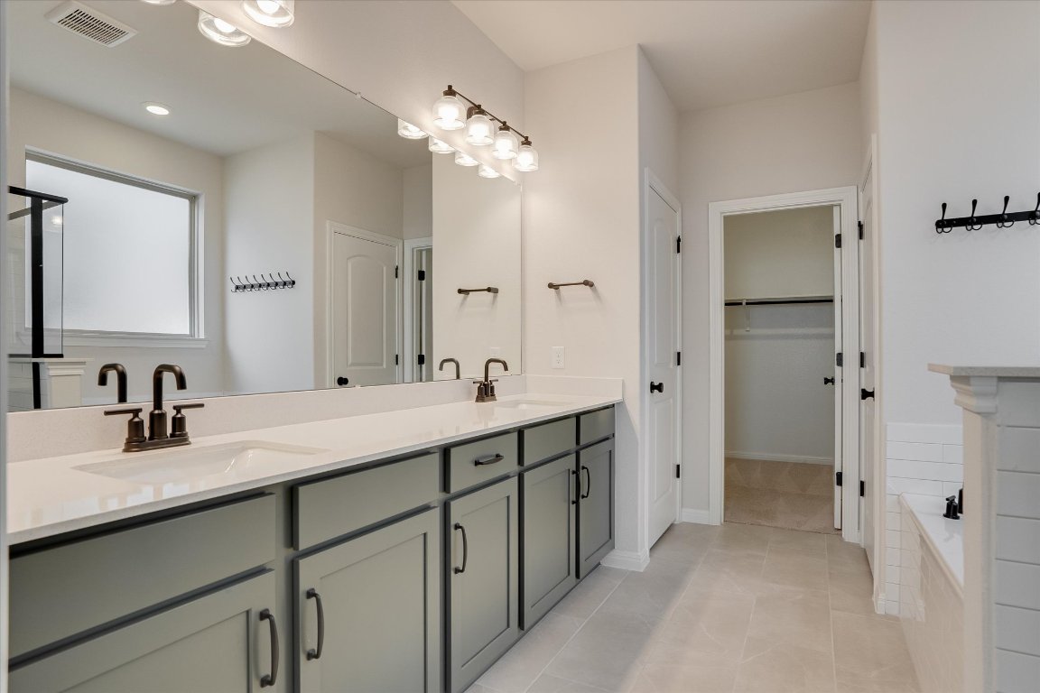 168 Kings Cyn Drive Dripping Springs, TX 78620 - Photo 13 of 25 a bathroom with a double vanity sink mirror and shower