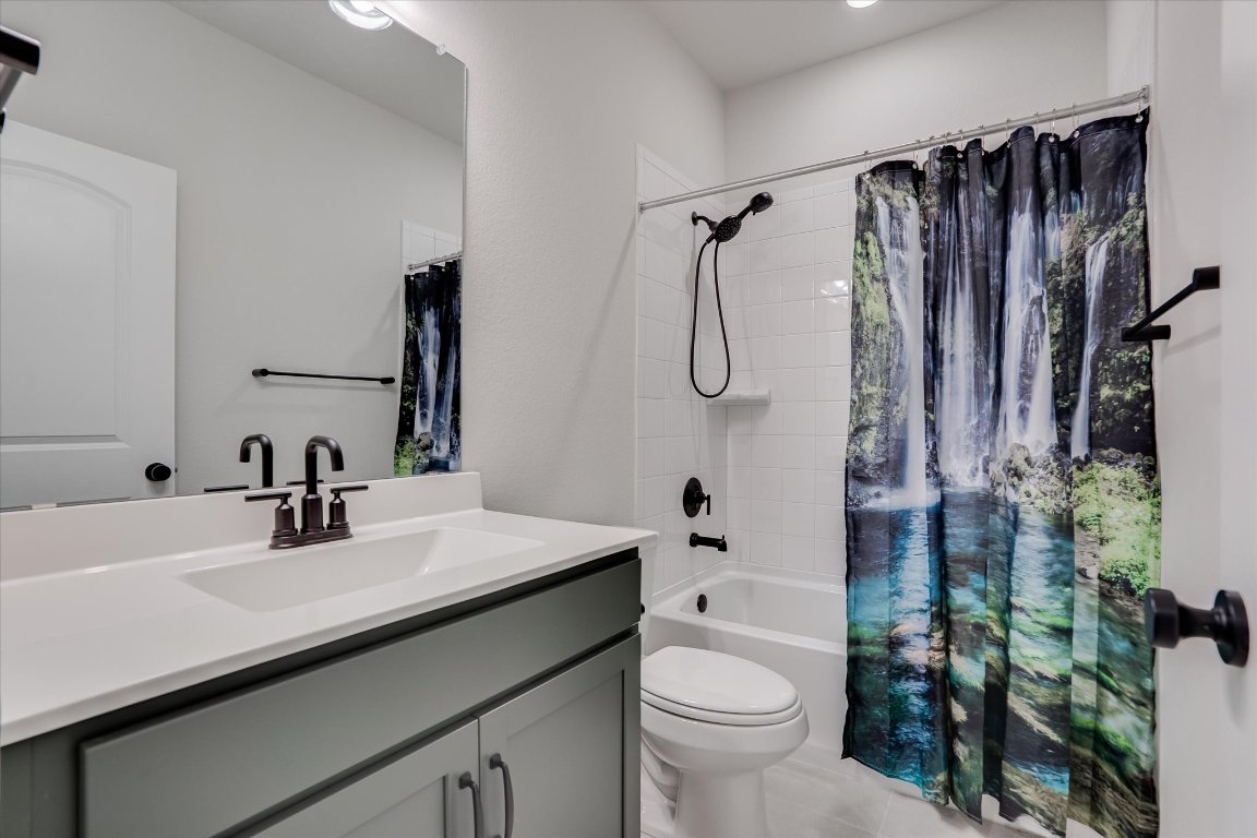 168 Kings Cyn Drive Dripping Springs, TX 78620 - Photo 17 of 25 a bathroom with a sink a toilet and shower