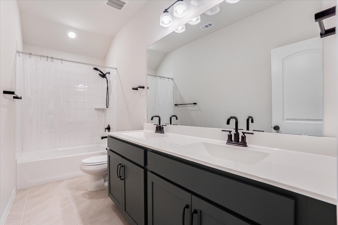 168 Kings Cyn Drive Dripping Springs, TX 78620 - Photo 19 of 25 a bathroom with a sink a toilet a tub and a mirror